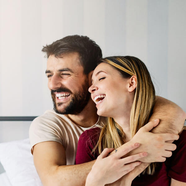 man and woman smiling together