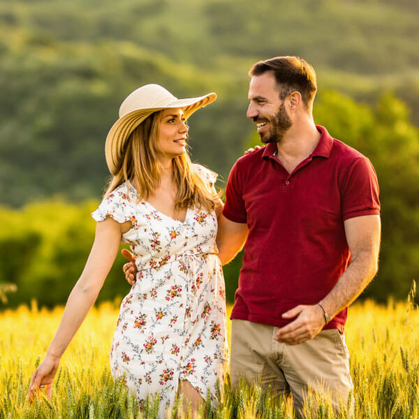 man and woman smiling together outdoors