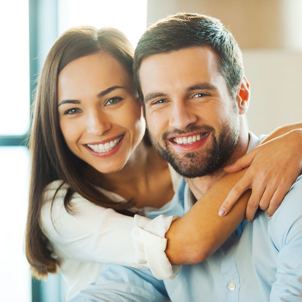 man and woman smiling together