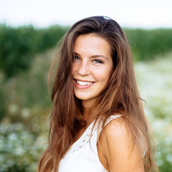 young woman smiling outdoors