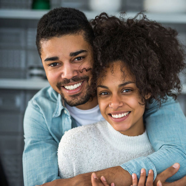 man and woman smiling together