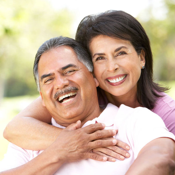 mature man and woman smiling outdoors