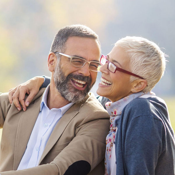 mature man and woman laughing outdoors