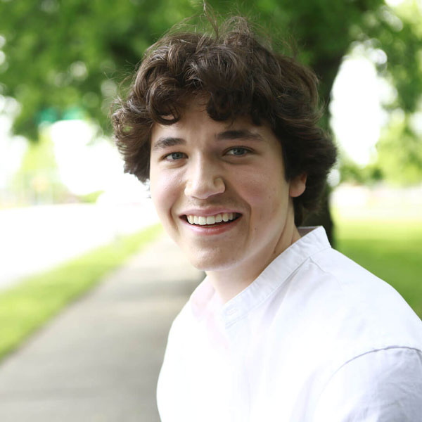 young man smiling outdoors